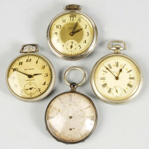 Lot of 4: Open Face Pocket Watches.: Includes one New Haven working sporadically, one with loose lens and train engine on back, one Westclox that is not working, and one key-wind watch missing its hands. Size: Largest: 2" Dia.
