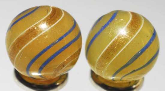 Lot of 2: Same Cane Butterscotch Lutz Marbles.: Pair of butterscotch lutz marbles with blue bands with nice even lutz bands. Marbles are very symmetrically made. A few as-made indentations and minor chipping. Size: Each: 9/16" Dia.