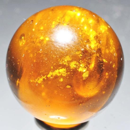 Single Pontil Mica Marble.: Honey amber with nice single pontil mica. One as-made service indentation. Size: 7/8" Dia.