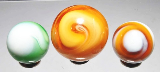 Lot of 3: Christensen Slag Marbles.: Includes two amber slags, largest with great nine pattern and smaller with beautiful nine pattern in white. Also includes one green slag with nice nine pattern in white. Size: Range: 13/16" to 1 - 1/8