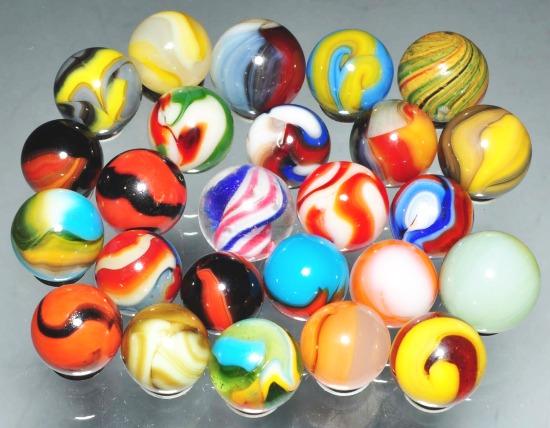 Lot of 25: Marbles.: Includes one onionskin, one peppermint swirl, one gray peltier liberty and Christmas tree, two peltier tigers, one Christensen and various other machine mades. Size: Range: 5/8" Dia. to 11/16" Dia.