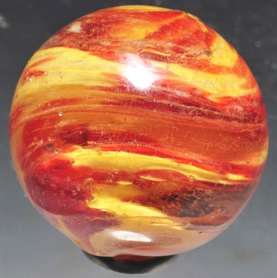 2-Lobed Onionskin Marble.: Deep lobed onionskin, yellow and orange with heavy twist. Has been re-melted but has no chips. Size: 1 - 1/16" Dia.