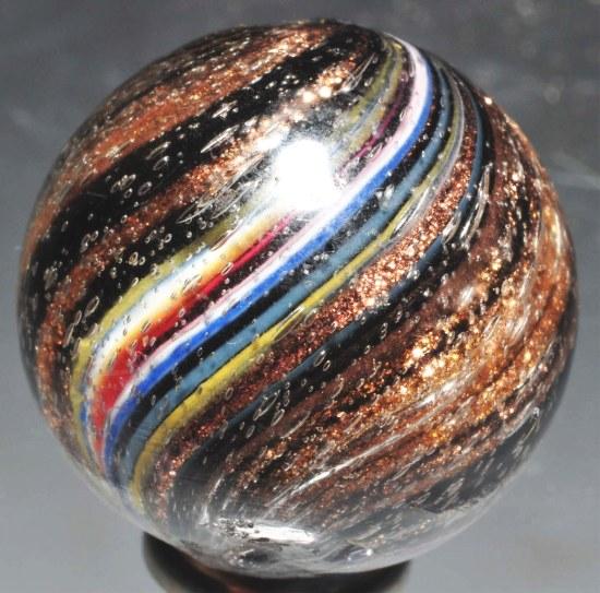 Large Indian Lutz Marble.: Panels of blue, yellow, white, red, and turquoise on a nice black Indian base. Very hard-to-find type of lutz marble, especially in this size. (8.4). Size: 7/8" Dia.