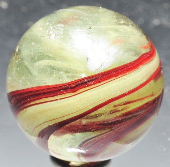 Large Leighton Oxblood Transition Marble.: Transparent clear glass with egg yoke and oxblood in great pattern around marble. A few as-made indentations and one shallow chip near faceted pontil. Size: 1 - 1/8" Dia.