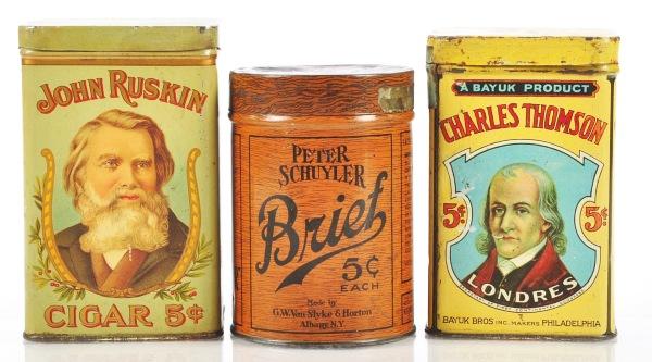 Lot of 3: Cigar Tins.: Nice includes colorful John Ruskin 5¢ Cigars, Charles Thomson Londres Cigars, and round wood grain finished Peter Schuyler's 5¢ Brief Cigars. Size: Largest: 5 - 1/2" T.