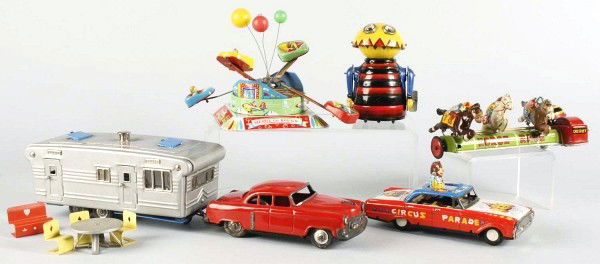Lot of 5: Tin Litho Wind-Up & Friction Toys.: Japanese. Working. Includes one friction Circus Parade car, one friction car and trailer set with furniture inside, one Marx wind-up Chompy the Beetle missing ears, one Japanese wind-up merry-go-round