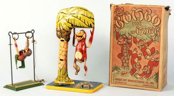 Lot of 2: Tin Litho Monkey Wind-Up Toys.: American. Includes Unique Art Bombo the Monkey toy in original box and Marx Swinging Monkey toy. Bombo's left rubber ear is broken off and missing. Original box with one top flap detached, two inner f