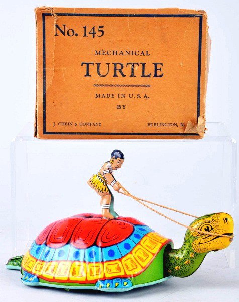 Tin Litho Chein Native Riding Turtle Wind-Up Toy.: American. Working. Colorful lithography with very little overall wear. Includes partial original box marked "No. 145 Mechanical Turtle". Top flaps detached but present and one piece is missing from bo