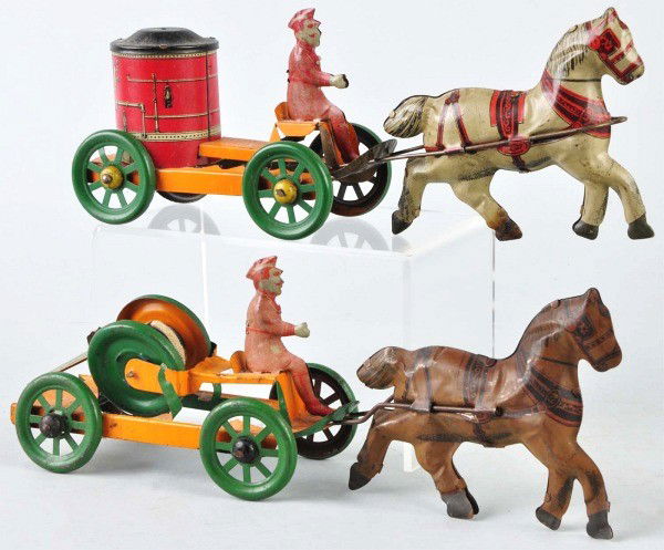 Lot of 2: Tin Litho Chein Horse-Drawn Fire Toys.: American. Both are identical pumper and hose realer pull toys. One horse has darkened litho with scratching and wear overall. Size: Each: 14 - 1/2" L.