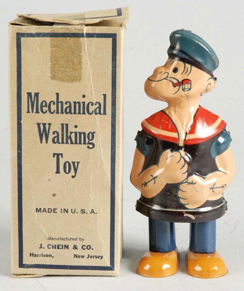 Tin Litho Chein Popeye Waddler Wind-Up Toy.: American. Working. Variation without "Popeye" on hat. Toy has some overall scratching and wear. Includes scarce original box with tab on top flap that is detached and currently taped on. Box also has 