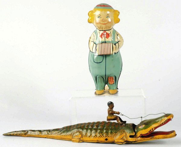 Lot of 2: Tin Litho Wind-Up Toys.: American. Includes Lindstrom Dancing Doll and Chein Native Riding Alligator, which is over wound. Some scratching and wear overall to both toys. Size: Largest: 15" L.