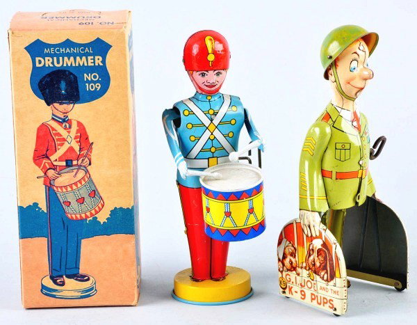 Lot of 2: Tin Litho Figural Wind-Up Toys.: American. Includes Chein no. 109 Mechanical Drummer toy in original box with beautiful graphics. Also includes Unique Art G.I. Joe and the K-9 Pups. Some scratching and wear overall. Size: Largest: 9"