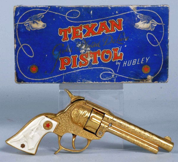 Hubley Gold Texan in Box.: Has fired caps. Box is shrink wrapped. Gun (Very Good - Excellent) Box (Good - Very Good). Size: 9" L.