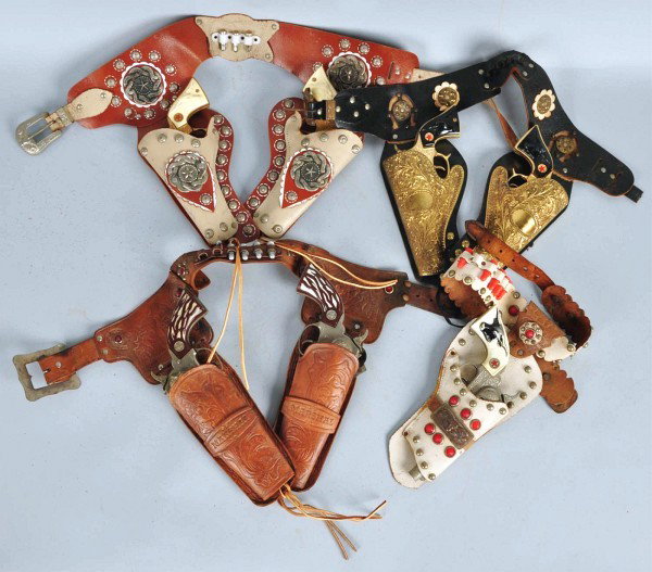 Lot of 4: Hubley Gun & Holster Sets.: Includes holster with two gold Texans, guns have been spray painted gold to cover their finish wear and holster is dried out. Also includes one white set, one Double Marshall set, and one Gold Texan J