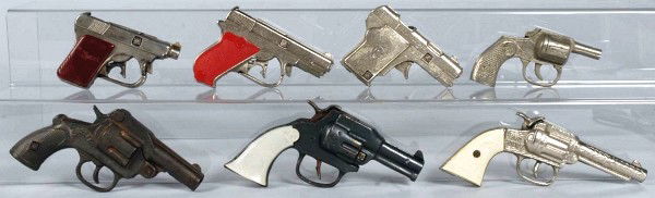 Lot of 7: Assorted Cast Iron Cap Guns.: Includes one Big Scout, one Hi-Ho, one Safety 50 Shot, one Wizard that is not working, two Captains, and one Mountie. Size: Largest: 7 - 1/4" L.