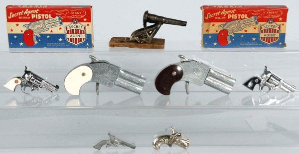 Lot of 7: Assorted Small Cap Guns.: Includes one 1890 Mouse Trap Cannon and six others. Two guns have thier original boxes. Size: Largest: 5 - 1/2" L.