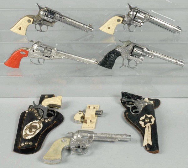 Lot of 8: Cap Guns.: All guns work well. Includes Nichols 38s, Grizzly, and others. Size: Largest: 11 - 1/2" L.