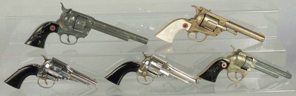 Lot of 5: Cap Guns.: Includes one Remington 36, one Remington with four bullets, one Texan 38 with five bullets, one Cowboy Jr., and one large Cowboy. Size: Largest: 12" L.