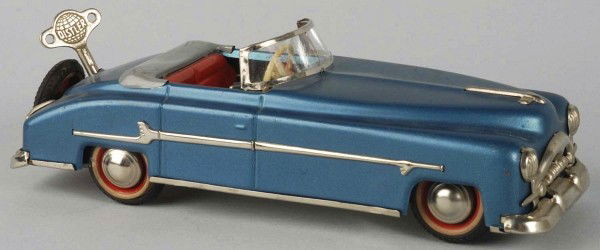 Tin Distler Packard Automobile Wind-Up Toy.: German. Working. Original rear mounted spare and key. Marked "Made in US Zone Germany" on bottom. Minor scratching and wear overall. Size: 10 - 1/4" L.