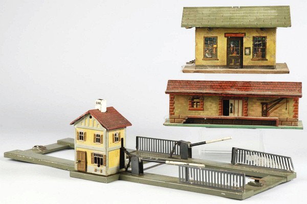 Lot of 3: Tin Litho Bing Train Accessories.: German. Nice lithography. Includes two stations and one station crossing gate section. One station is missing piece from roof and lot has overall paint loss and wear. Size: 22" L.