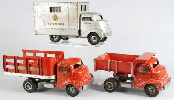 Lot of 3: Pressed Steel Smith-Miller Truck Toys.: Includes one GMC front dump truck and one GMC front stake truck. Both have Smith-Miller decals on cab doors. Some scratching and wear, especially to cab fronts and roofs. Size: Largest: 14 - 1/2" L.