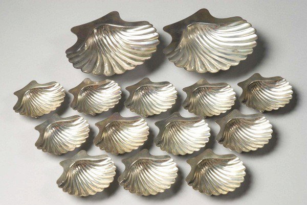 Lot of 14: Silver Seashell-Shaped Dishes.: Includes two large nut dishes and 12 smaller dishes. All are marked "Sterling". Lot weighs 15.2 troy ounces. Size: Largest: 5" x 5".