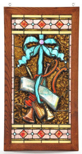 Music Themed Leaded & Stained Glass Window.: Oak frame. Stained and plated glass window with music theme featuring a lyre, clarinet, and sheet music. Turquoise ribbon with pink jewel. Size: 47 - 1/2" x 25".