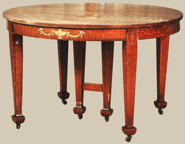 Round Oak 6 Legged Table.: Original finish with applied swag and urn decoration. Size: 48" Dia.