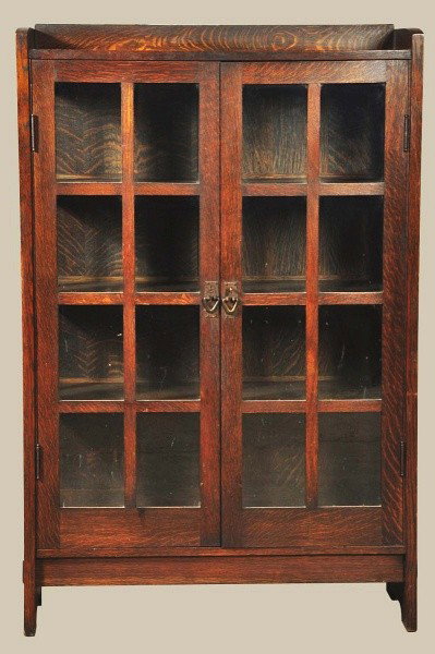 Gustav Stickley China Cabinet.: Original finish and hardware. Remnants of paper decal on back. Possible light over varnish and minor wear to feet. Size: 41 - 1/2" x 64".