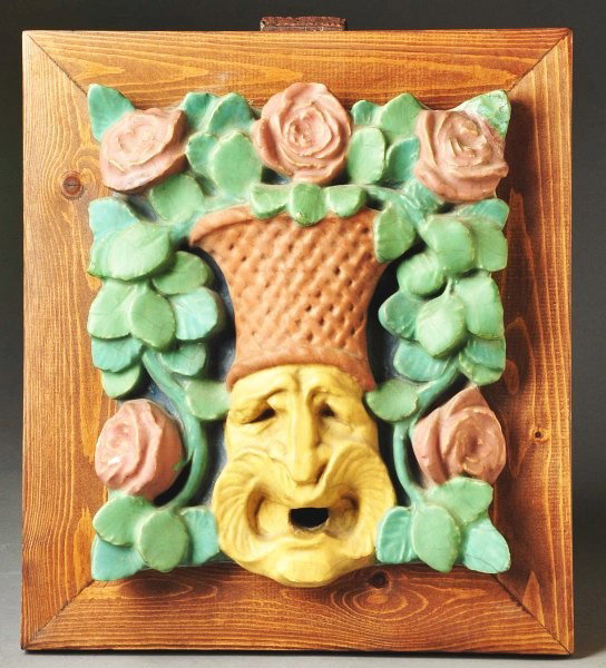 Rookwood Faience Jester Tile.: With basket and roses spilling out. Has two minor chips, a glaze flake and crazing. Back has one large chip not seen from front. Framed in a stained pine frame. Size: Framed: 18" x 16 - 1/4".