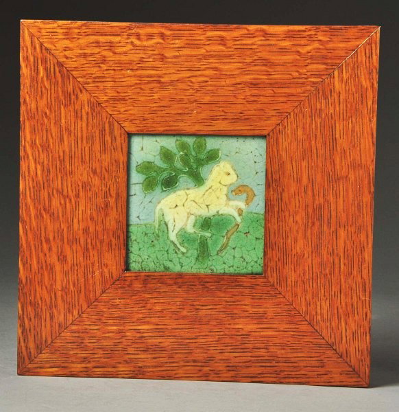 Grueby 5-Color Faience Tile.: Depicts a cat holding a snake in a contemporary oak frame. Minor glaze loss and crazing. Size: Framed: 10" x 10".