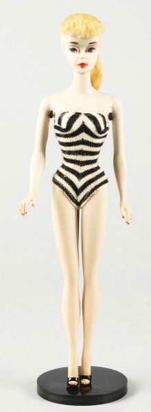 1960 No. 3 Blonde Barbie Doll.: 3rd Barbie doll with brown eyeliner wearing original swimsuit. Includes pedestal stand, sunglasses, number 1 style shoes, gold hoop earrings, and booklet. (Excellent condition, faint discoloration at