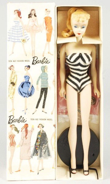 Blonde No. 3 Barbie Doll in Box.: 1960 Barbie doll with original swimsuit, pedestal, booklet, pearl earrings, and shoes. Original hair set. (Near Mint condition. Doll retains some of its pinky coloring and cheek blush). Size: