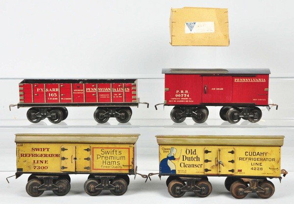 Lot of 4: Bing Gauge 1 Freight Train Cars.: German. Includes one boxed Pennsylvania maroon boxcar with gray roof, one Swiss Premium Hams refrigerator car missing both door handles, one Old Dutch Cleanser refrigerator car with pitting to roof an