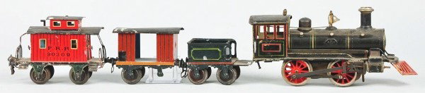 Marklin Gauge 1 Steam Engine Freight Train Set.: German. American profile. Clockwork motor. 0-4-0 wheel alignment. Includes locomotive with cow catcher, four wheel tender, baggage car, and red PRR 90309 caboose. Baggage car with badly damaged roof, 