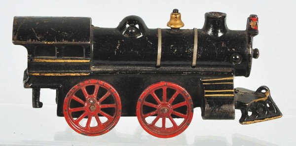 Ives Transitional War Train Locomotive.: Circa 1920. Locomotive only. Cast iron 0-4-0 loco with tin boiler straps. Fairly scarce example with nice gold striping on steam chest. Provenance: The Ward Kimball Collection. Size: