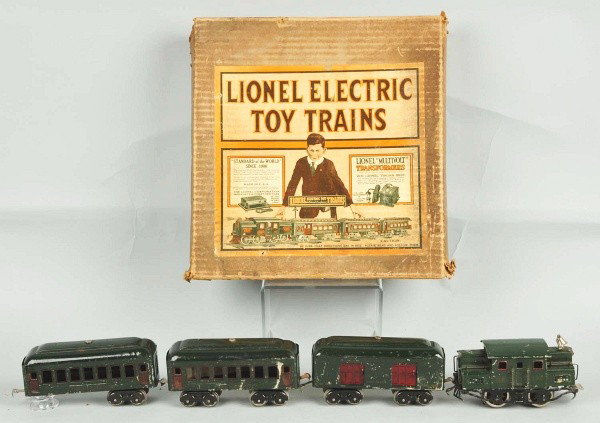 Tinplate Lionel O Gauge No. 164 Outfit Set.: American. Pre-war. Includes 152 electric-style engine, two 601 pullman cars, and one 602 New York Central Lines baggage car. Set with moderate scratching throughout. Includes original box with some cr