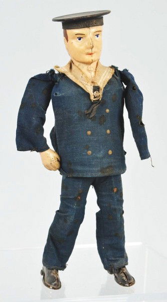 Tin Lehmann Sailor Wind-Up Toy.: German. Handpainted face, original clothing, and original tassel on hat. Missing left arm and clothing is tattered. Size: