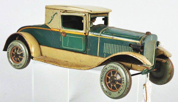 Tin Litho Karl Bub Sedan Car Toy.: German. Electric motor. Marked "Dunlap" on wheels. Original tin litho driver, opening doors, fold out rumble seat, and license plate in back. Some scratching and wear throughout, especially on fenders