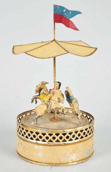 Tin Gunthermann Merry-Go-Round Wind-Up Toy.: German. Working. Handpainted. Toy consists of three figures riding goats. When in operation, figures spin around base while toy emits plink plink music. Flag on top is replaced and some paint loss to