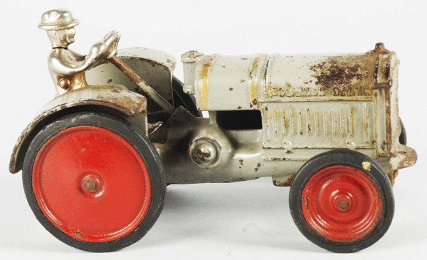 Cast Iron Arcade Tractor Toy.: American. Original nickel driver, disc wheels, and rubber tires. Marked "Arcade" on inside of one wheel. One 2" x 1" spot of paint loss and oxidation to front hood and rear fenders. Size: 7" L.