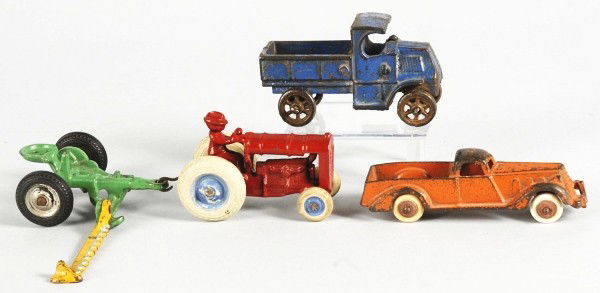 Lot of 4: Cast Iron Vehicle Toys.: American. Includes one Arcade tractor with rubber wheels, one Arcade hay cutter accessory, one Hubley LaSalle automobile, and one Arcade Mack truck. Some paint loss throughout. Size: Largest: 6 - 1/2"