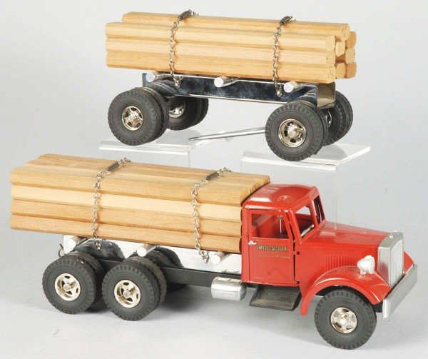 Lot of 2: Pressed Steel Truck Toys.: Includes one Smith-Miller PIE truck with restored cab and replacement rear doors on trailer. Also includes one Fred Thompson two piece lumber truck. Size: Largest: 31" L.