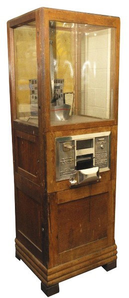 1932 Exhibit Digger Coin-Op Machine.: Patent number "90410". Appears to be all original except for newer 25 cent coin slide. Early grabber machine style with boat. One piece of cracked glass at left side. Fair original condition. Size: 67