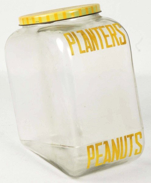 Planters Peanut Tall Slanted Jar with Lid.: Light soiling and slight fading to lid. Displays well. Size: 10" T. Condition: (Excellent - Near Mint).