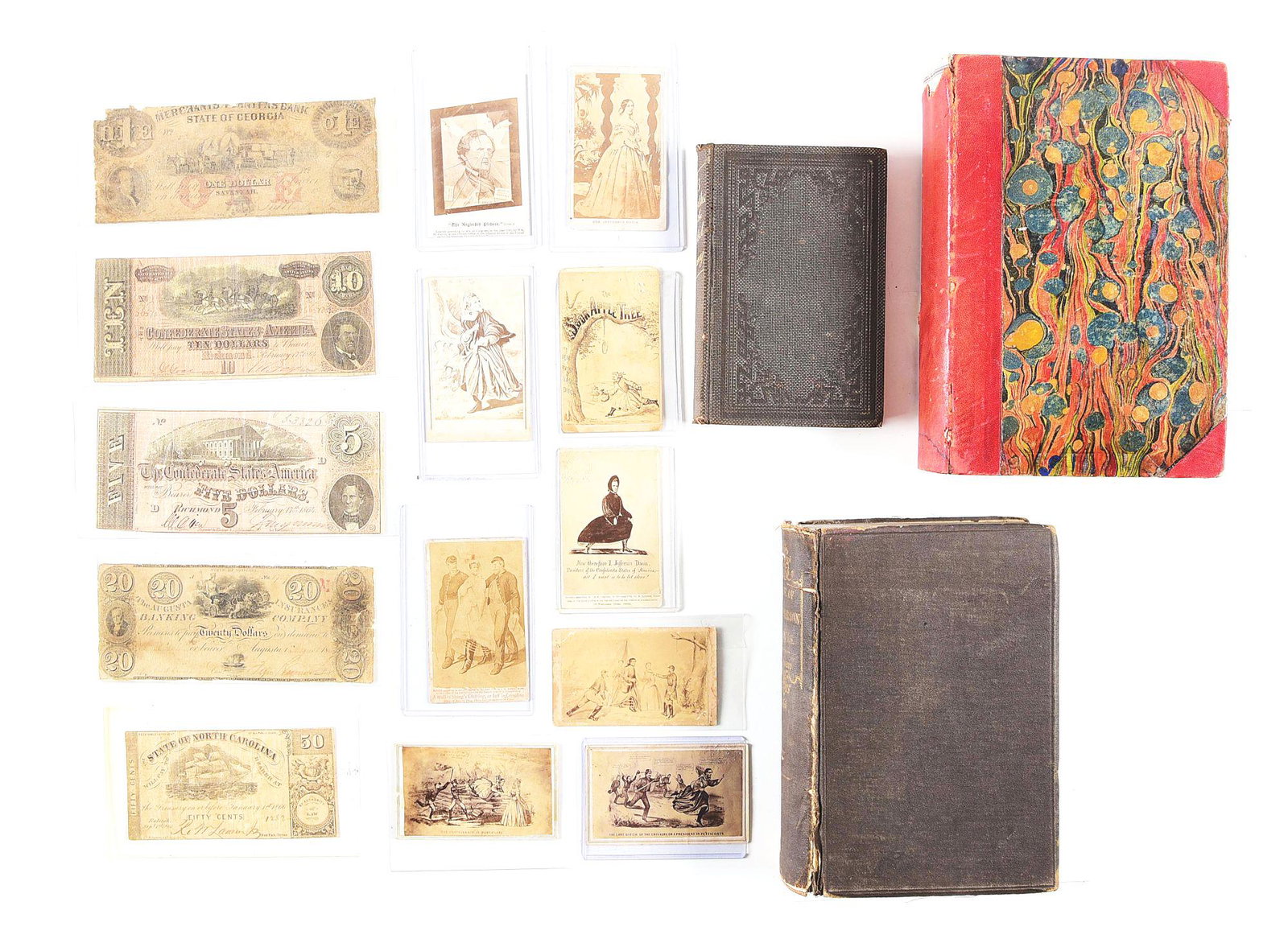 LOT OF JEFFERSON DAVIS SATIRICAL CDVS, CS CURRENCY, CS: Lot consists of 8 satirical carte-de-visite images of Jefferson Davis, 1 of his wife, 5 pieces of CS currency, 3 Confederate related period books The CDVs have various publishers. Most allude to Davis
