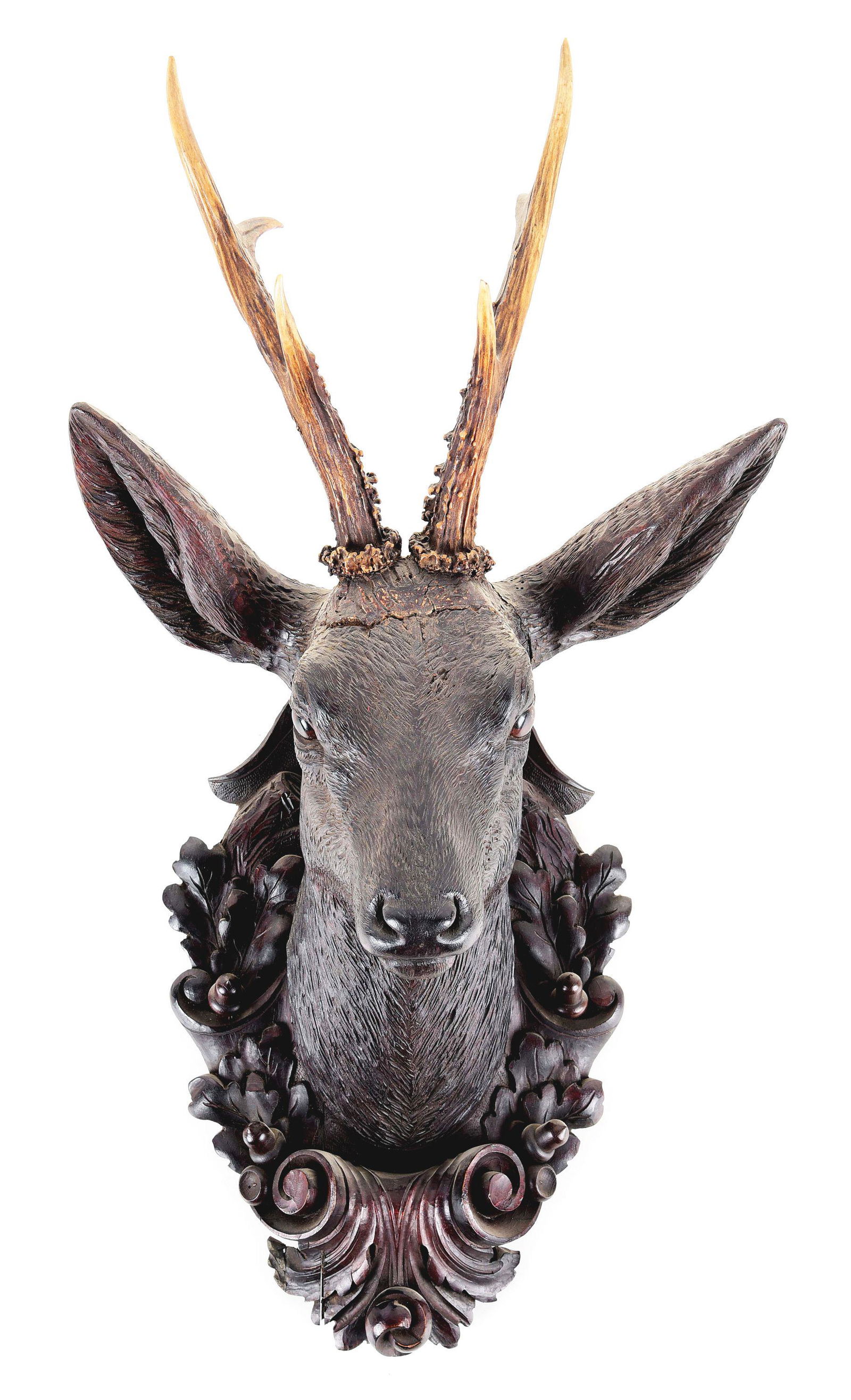 BLACK FOREST WOODEN ROEBUCK HEAD SCULPTURE: Late 1800s Black Forest mount. Beautiful and intricate detail with glass eyes. Original antlers. Comes with acorn and scrolled leaf mounting. CONDITION: Excellent.