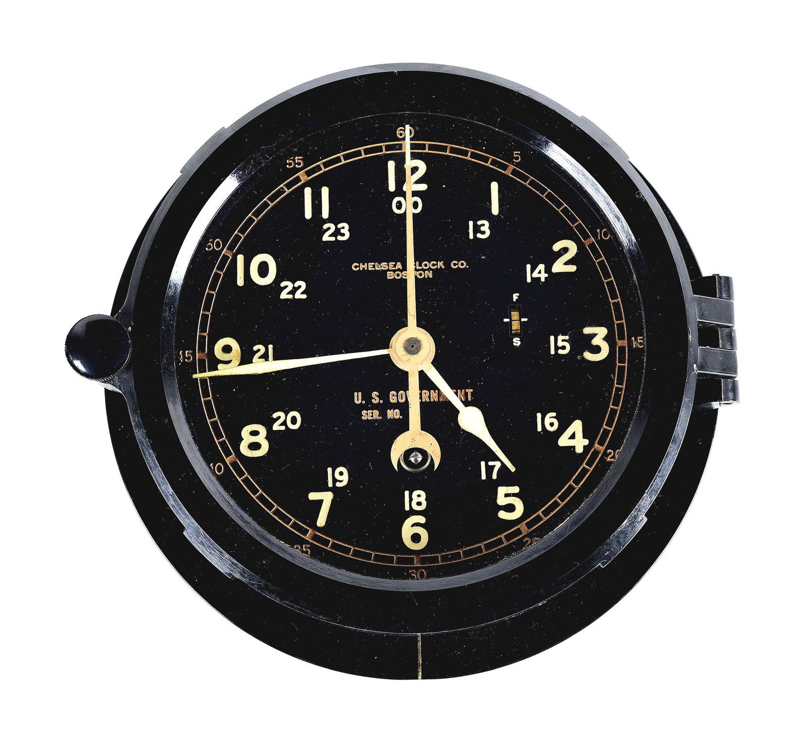VIETNAM WAR ERA CHELSEA SHIP'S CLOCK.: Nice example of a World War II era Chelsea Clock Co. ship's clock which was meant to be mounted on the wall of deck and engine rooms. The case is constructed of black phenolic resin and features a hin