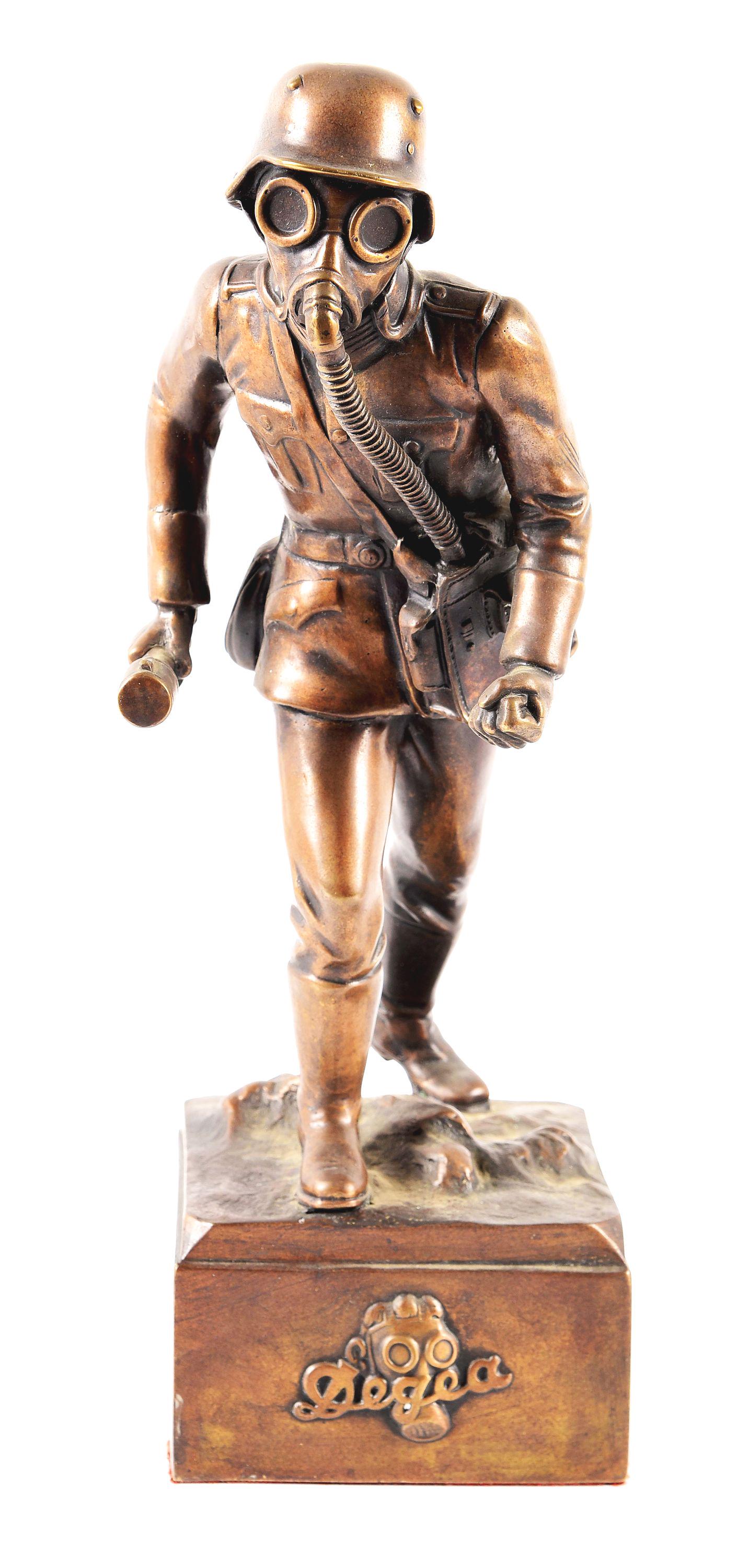 IMPERIAL GERMAN WWI BRONZE STATUE.: Imperial German World War I solid bronze statue depicting a soldier (perhaps a Sturmtruppe) wearing a helmet, gasmask, other basic field gear, and carrying a WWI grenade. Base is maker marked "Auer Ge