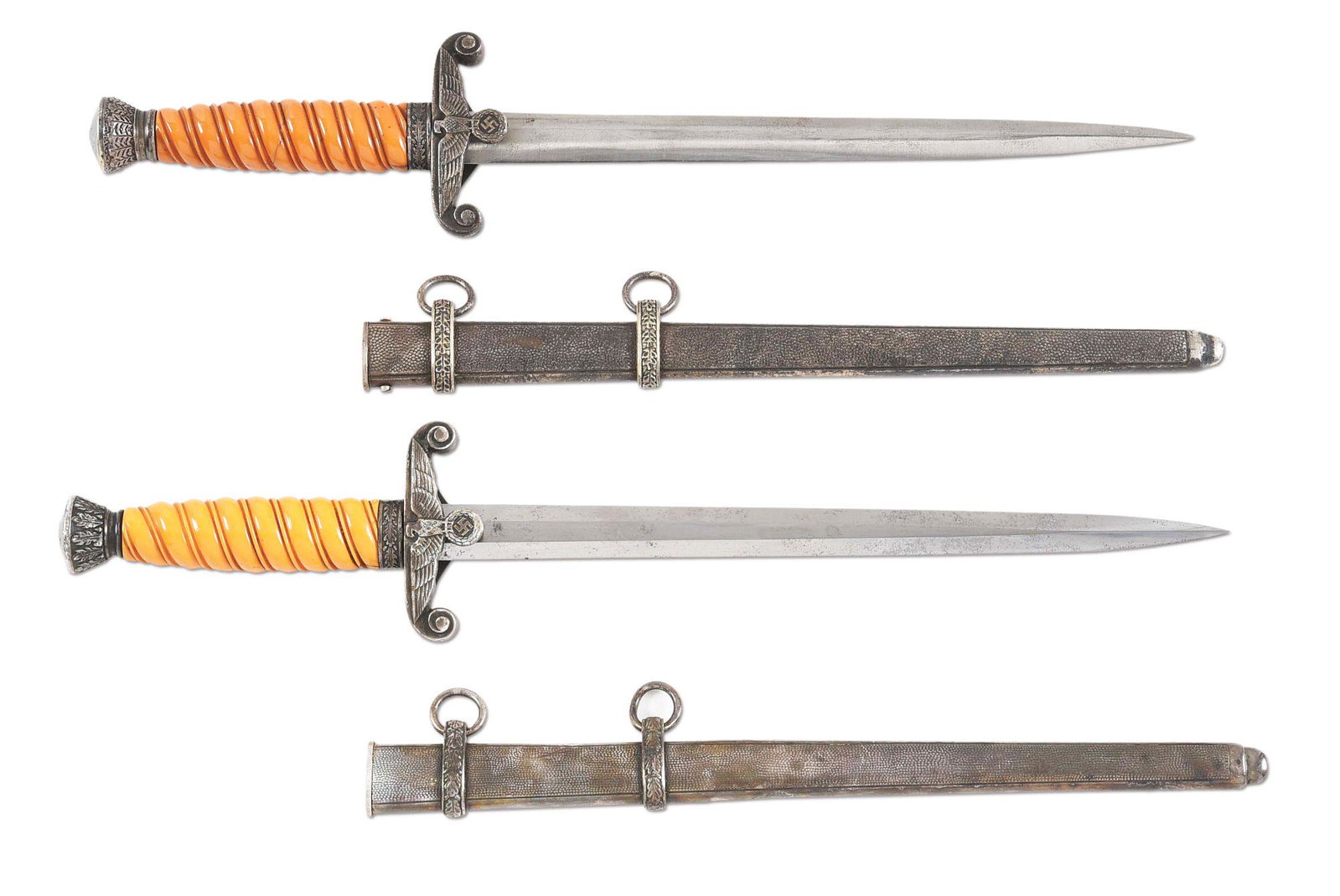 LOT OF 2: THIRD REICH HEER DAGGERS.: Lot contains: (A) Heer dagger with a "WKC, SOLINGEN" marked blade with light runner and scattered marks. Blade has been heavily polished and appears to have been sharpened as well. Nickel silver plate